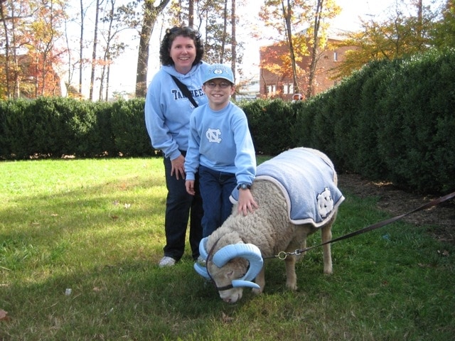 Beth Waldron and her son Evan with the UNC team mascot—a ram named Rameses.