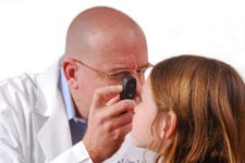 doctor looking at girls eyes