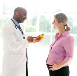 Doctor discussing medication with a pregnant woman