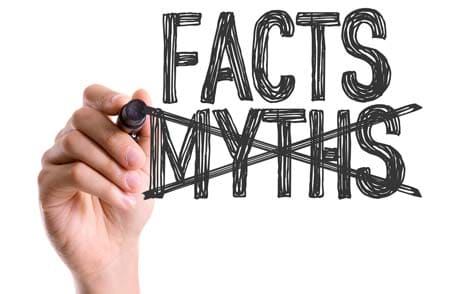 Hand with pen crossing out myths and showing facts