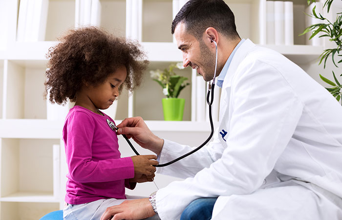 Doctor listening to a child's heart during doctor visit