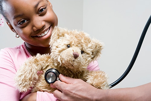 Girl and teddy with stethoscope