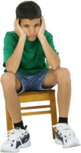 Frustrated boy sitting in a chair 