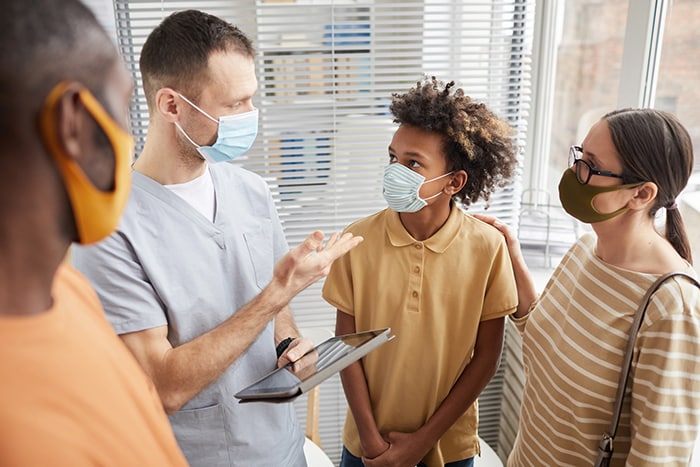 doctor talking to family in clinic