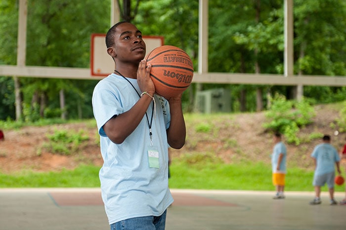A young man playing basketball