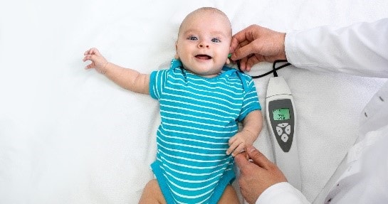 A baby having a hearing examination