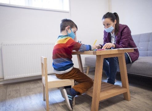 A young child working with his teacher