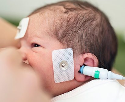 A baby receiving a hearing test