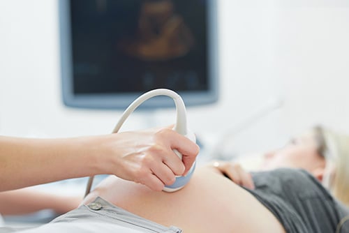 Healthcare provider uses ultrasound to check the health and development of a woman’s baby.