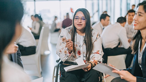 woman in wheelchair participating in a business conference