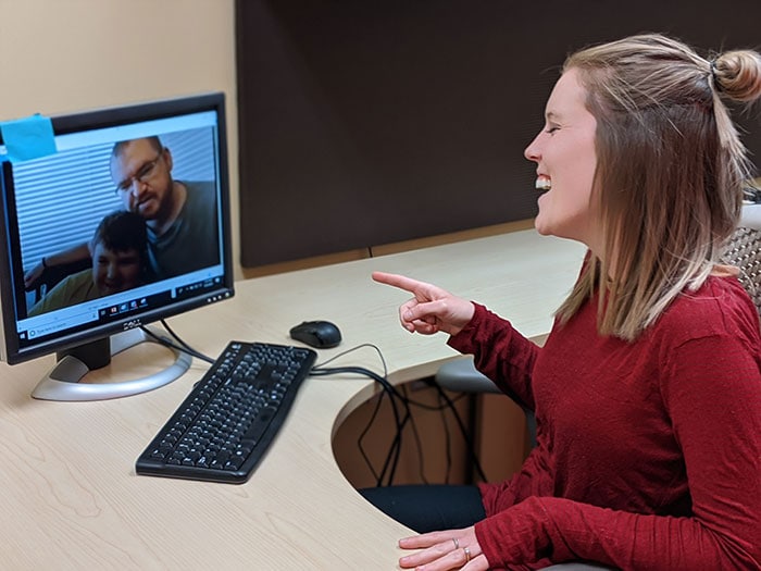A woman with a disability video conferencing with family