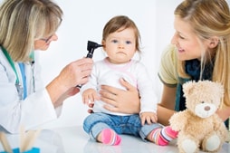 A doctor examining a baby