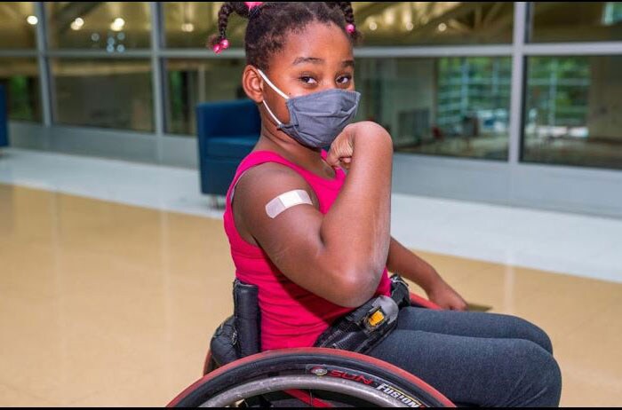 Girl in a wheelchair who just received a flu shot