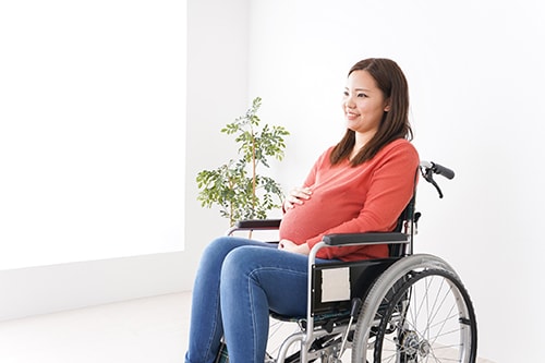 Pregnant woman ride in a wheelchair