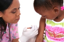 Nurse giving a little girl an immunization.