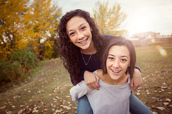 Hispanic Teenage girls having fun together outdoors