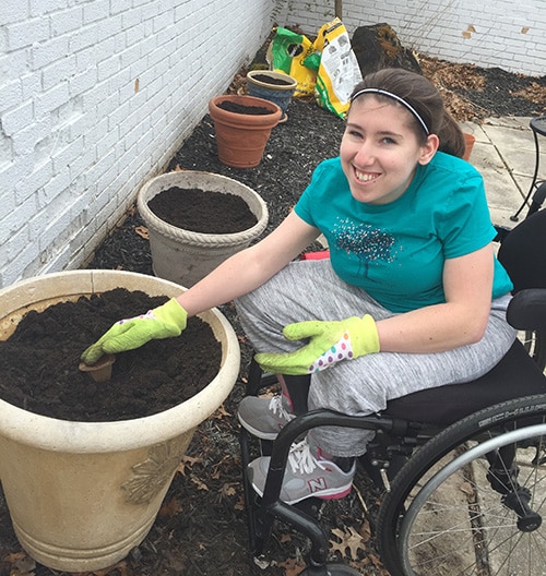 Young woman gardening from her wheelchair