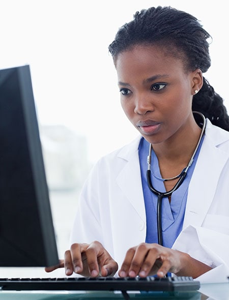 African-American woman doctor using a computer