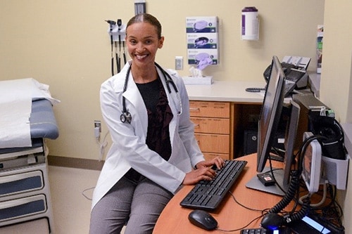 Researcher smiling at her desk