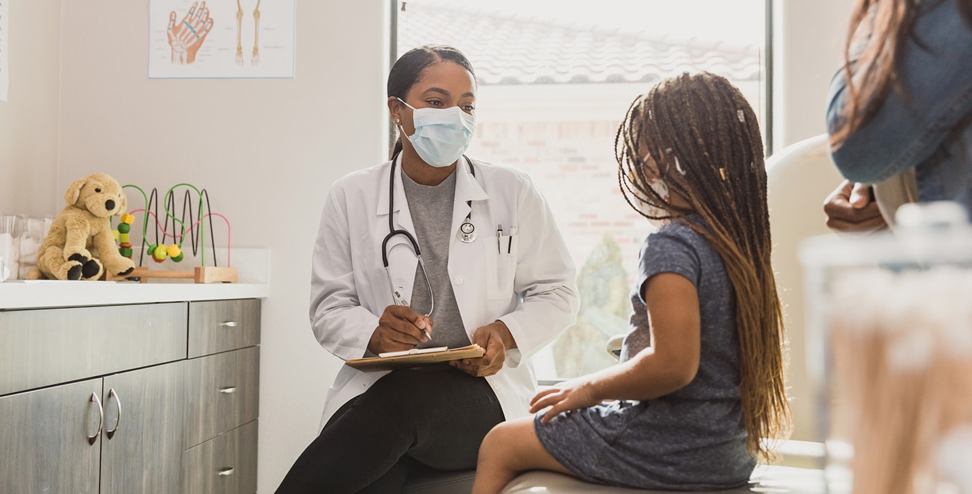 Young patient talks with pediatrician