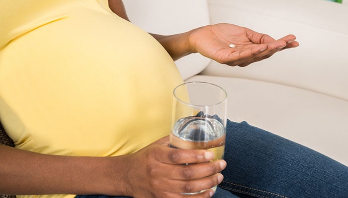 Pregnant woman taking medication