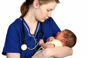 Healthcare provider holding a baby