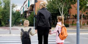 Mother about to cross road with son and daughter