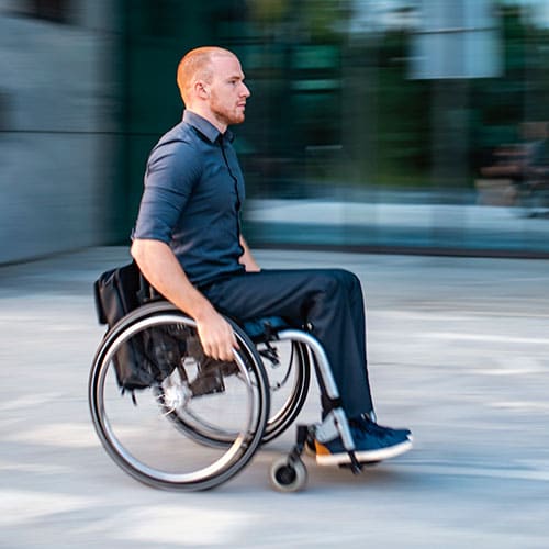 Corporate worker in a wheelchair on his way to work.