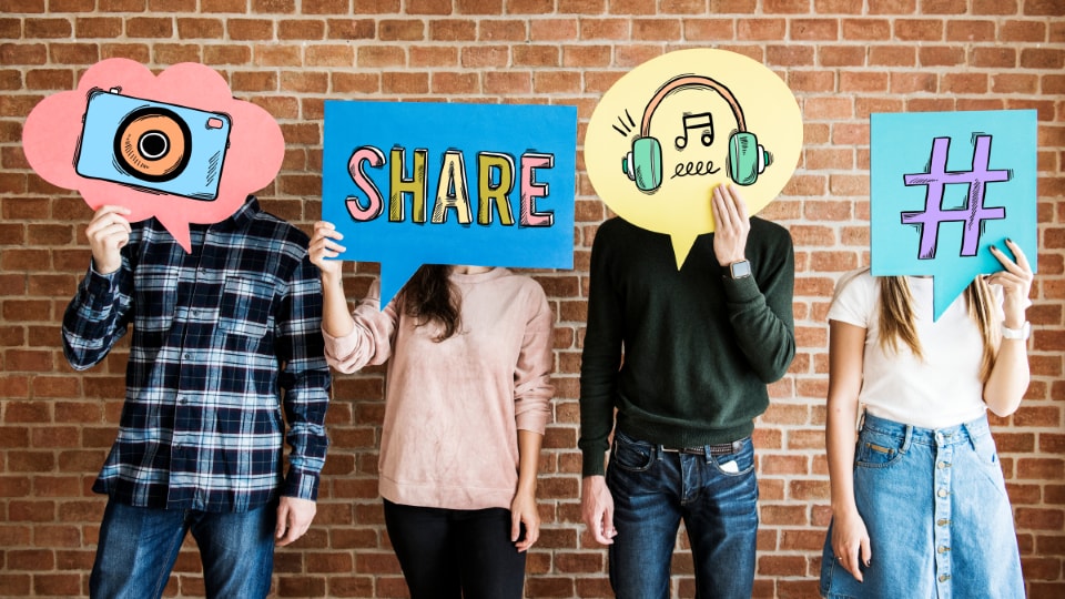 four people standing with social media symbols such as the pound sign