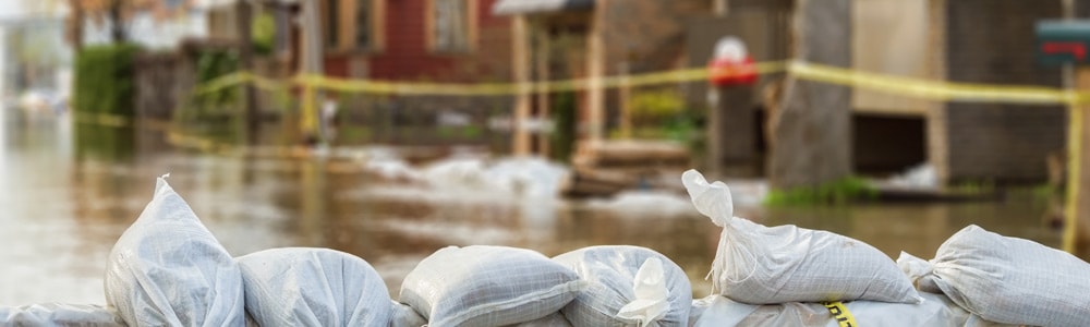Sandbags on a flooded neighborhood street.