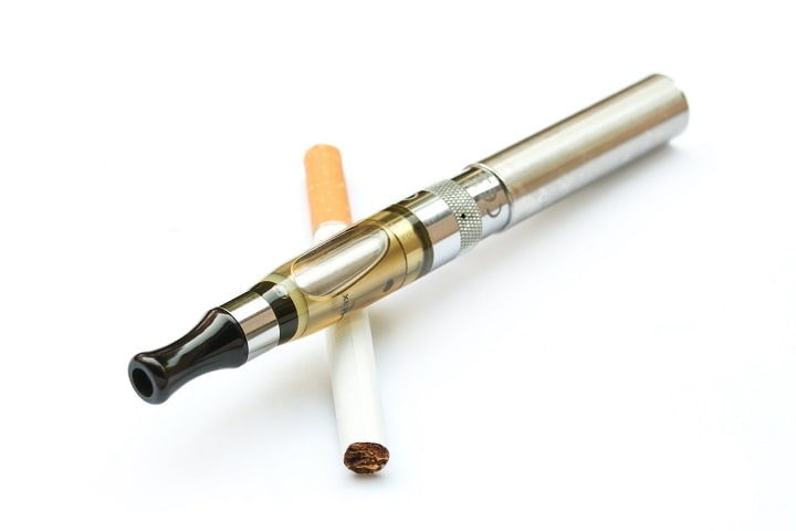 E-cigarette closeup with cigarette on white background