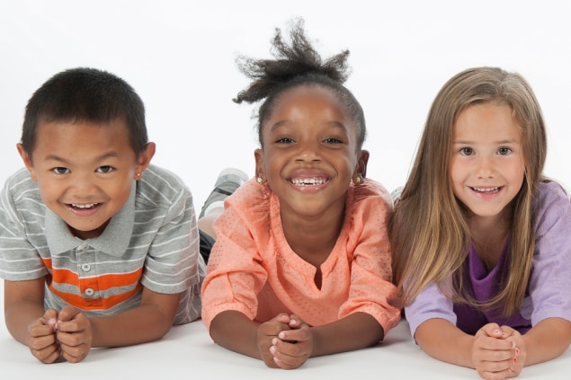 Photo of three smiling children