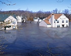 Photo of a neighborhood that is flooded with houses all in water.