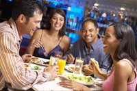 Photo of 2 couples dining at a restaurant.