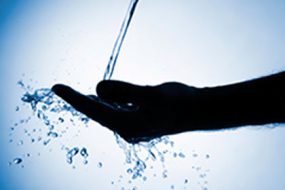Image of a hand cupped getting water.