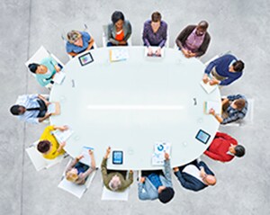Overview of people meeting at a circular table.