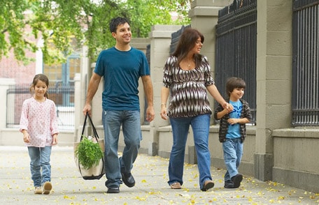 Family walking down sidewalk