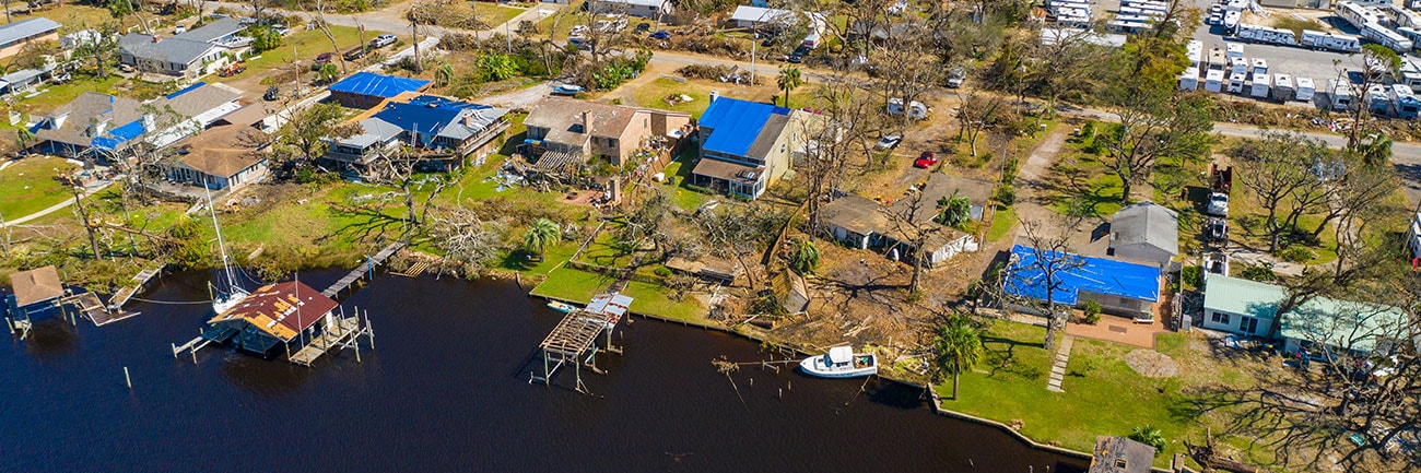 Aerial shot of a community recovering from structural damage after a natural disaster.
