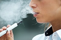 person smoking an e-cigarette