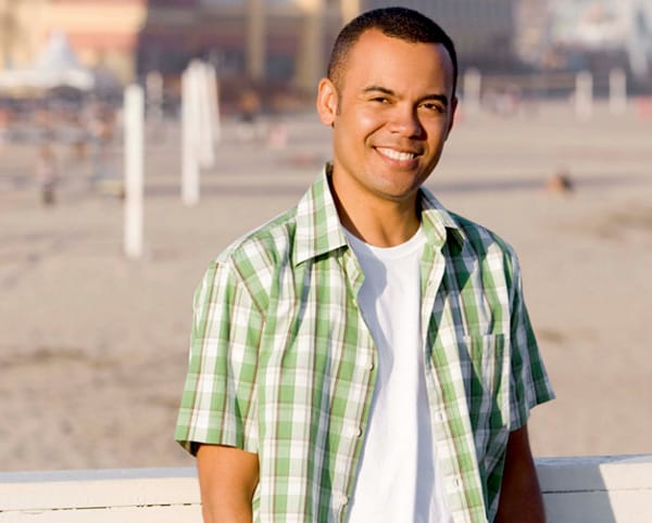 young man on the boardwalk at the beach