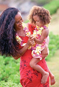 Mother in Hawaiian dress holding a child