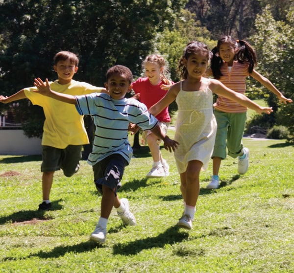 Children running on the grass