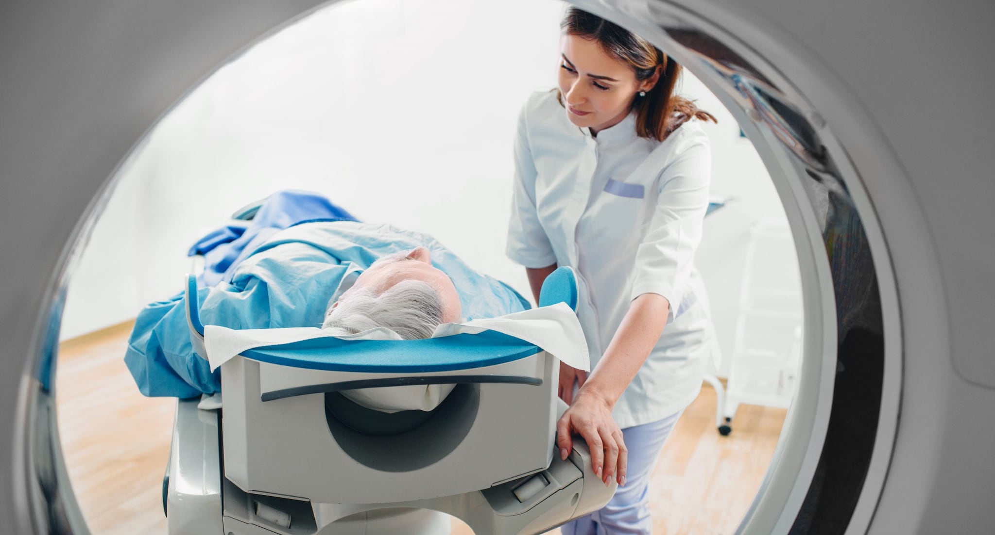 Female doctor talking to patient during hospital CT Scan