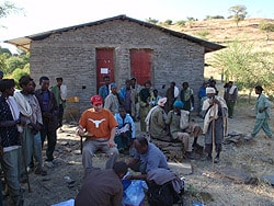 Matthew Murphy organizes the team for field work outside a health station.