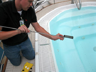 a summer intern sampling pool water