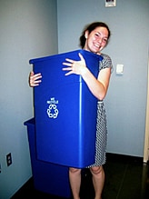 An intern embracing a recycling bin