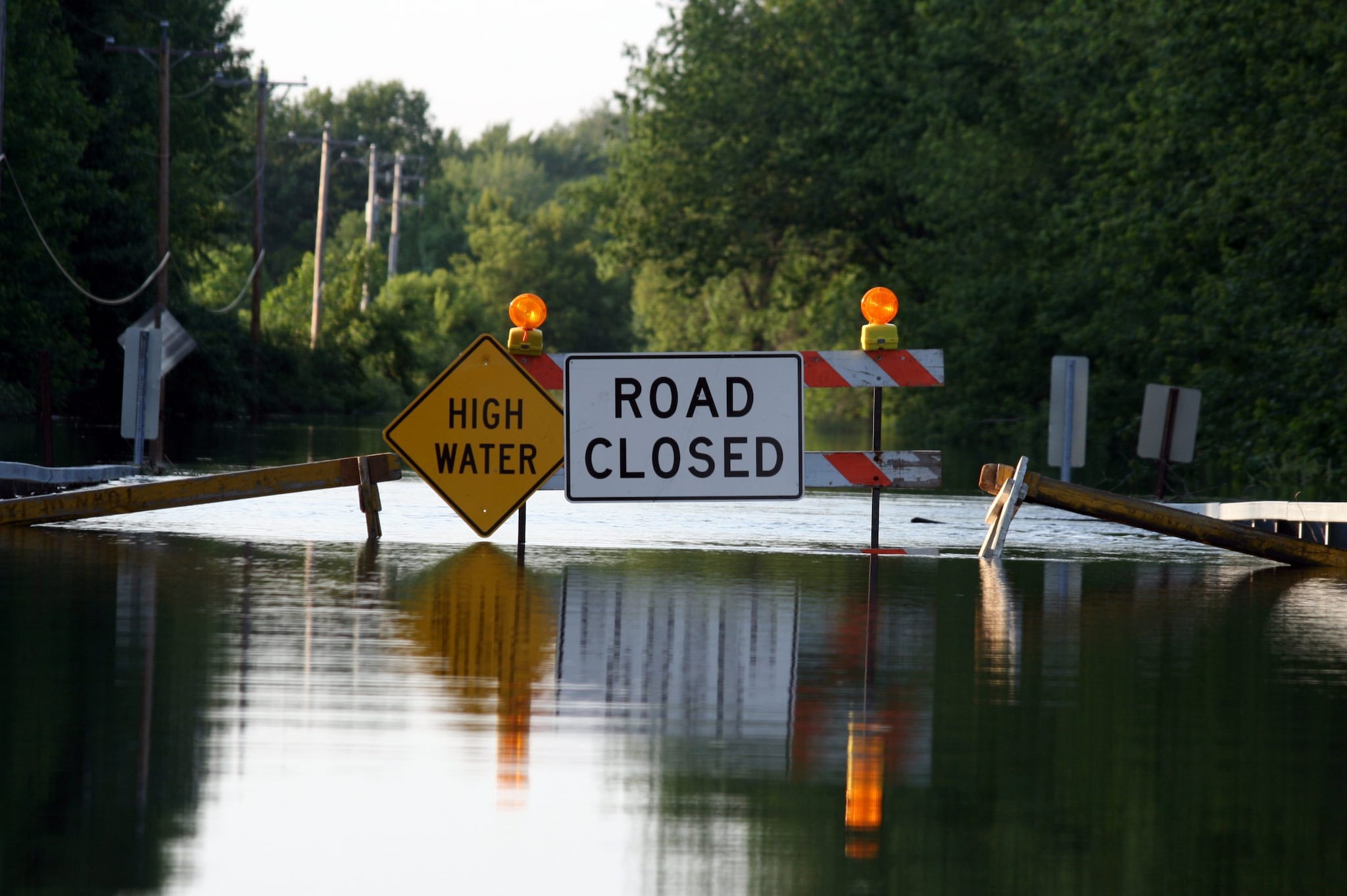flooding on road with road closed sign