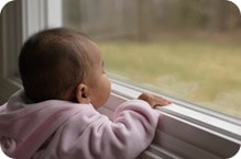 Baby looking out of window