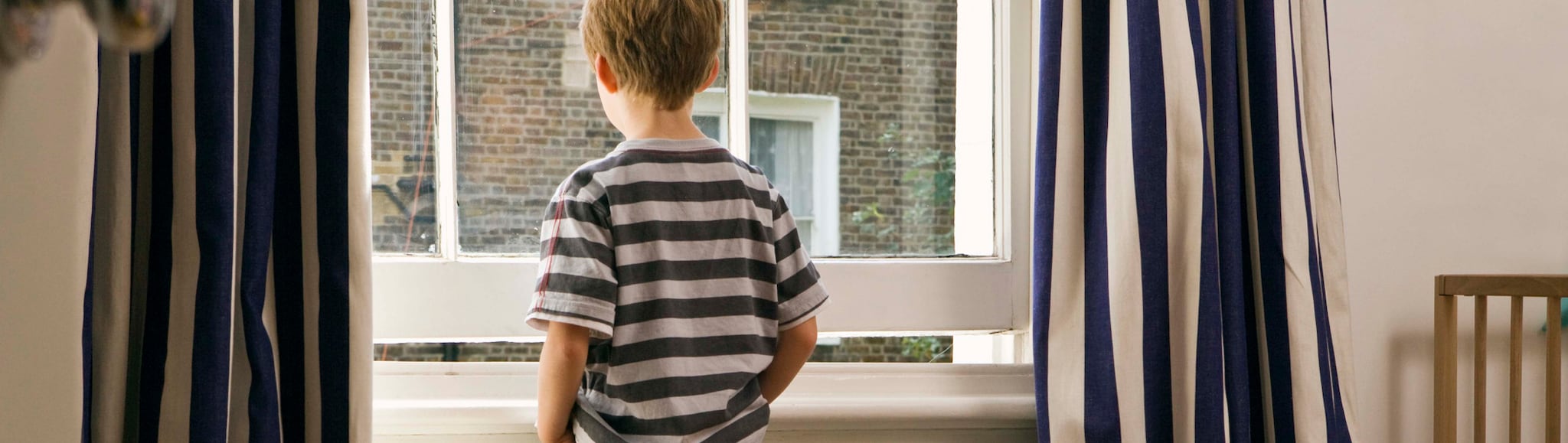 Young child looking out of window