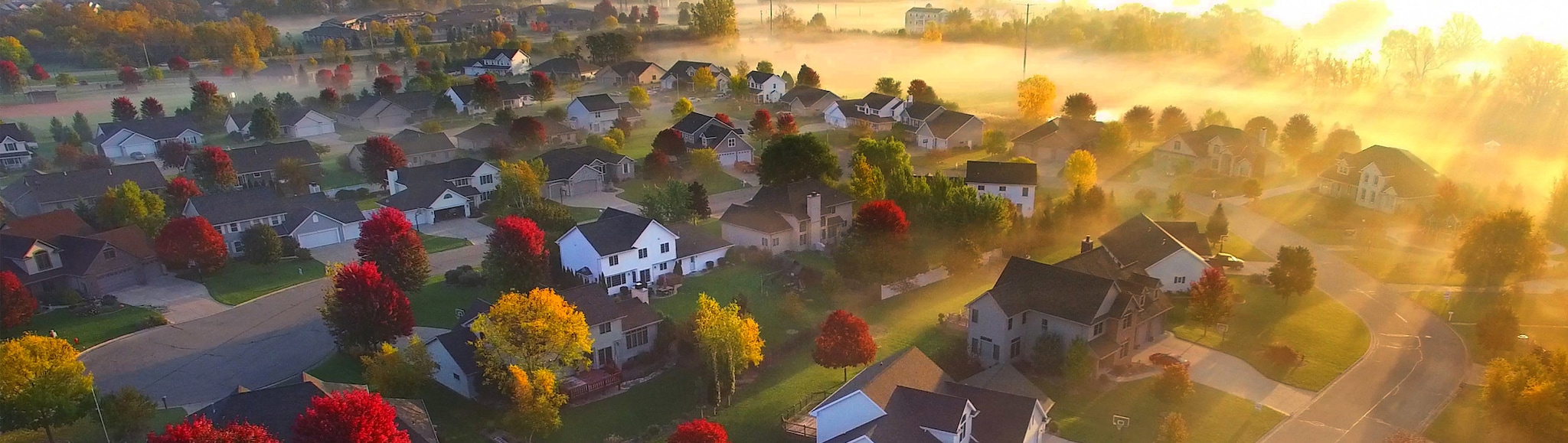 aerial view of neighborhood homes during sunrise